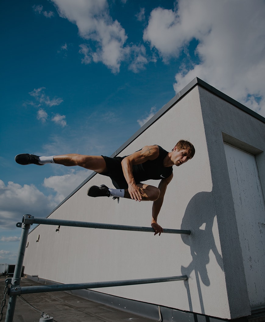 Picure of Laur jumping over a metal pole